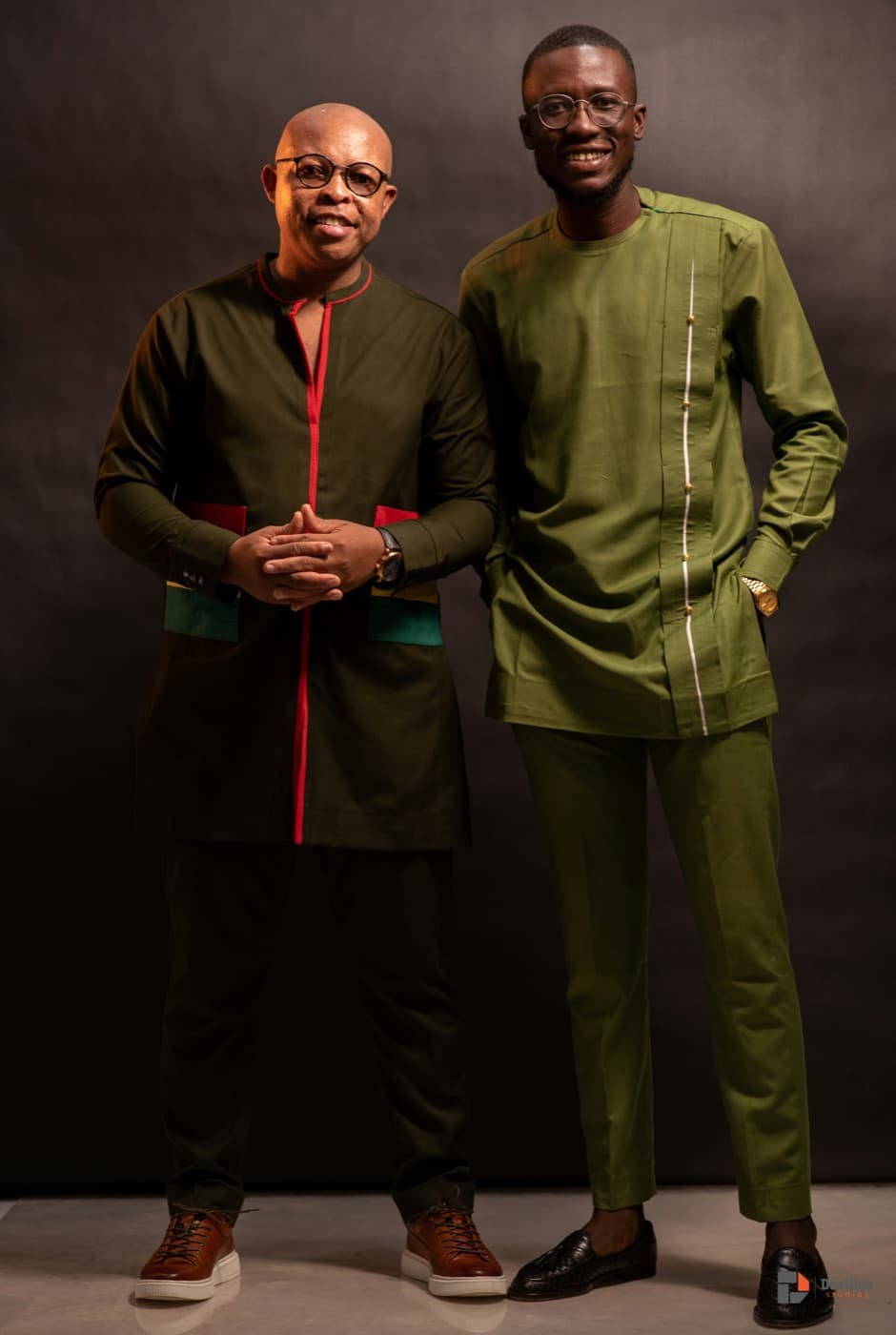 Two men in tailored modern Ghanaian outfits in a studio in Accra